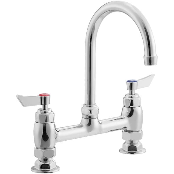 a silver faucet with red knobs