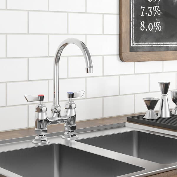 A Waterloo deck-mount faucet with a gooseneck spout above a sink with a blackboard on the wall.