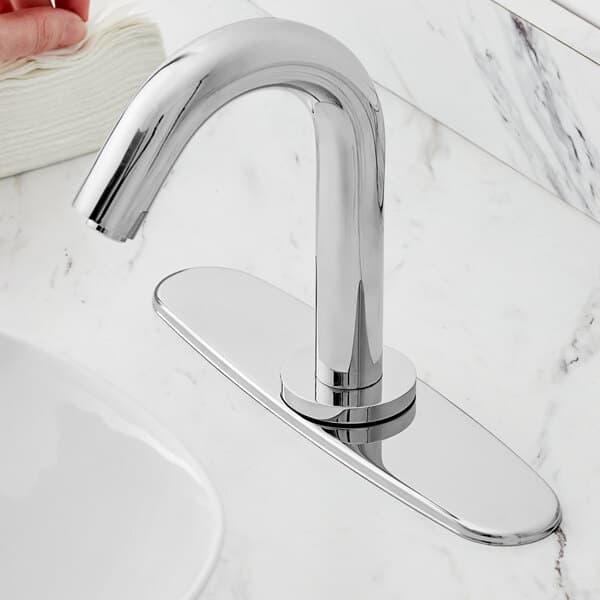 A silver Waterloo faucet deck plate installed on a marble counter.