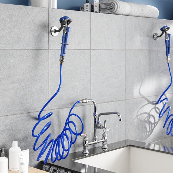 A Waterloo pet grooming faucet with blue hoses and a shower head.