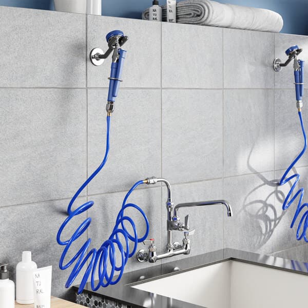 A Waterloo pet grooming faucet with blue hoses and a shower head.