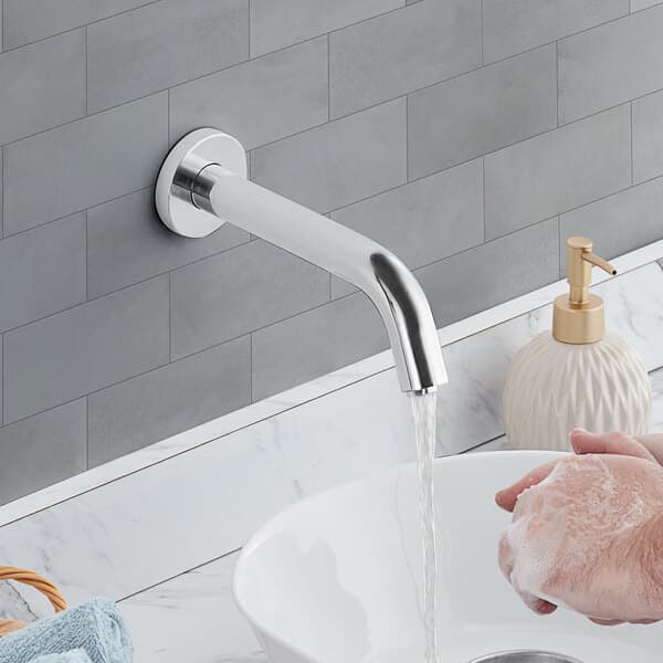 A person washing their hands under a Waterloo wall-mount hands-free sensor faucet.
